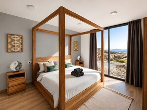 A four-poster bed with a view of a coastal landscape. - Exceptional Villa with Private Pool, Sea View, and Wi-Fi (Villaverde)