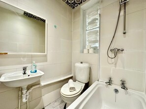 A bathroom with a sink, toilet, bathtub, and a shower. - The Borough Base (London)