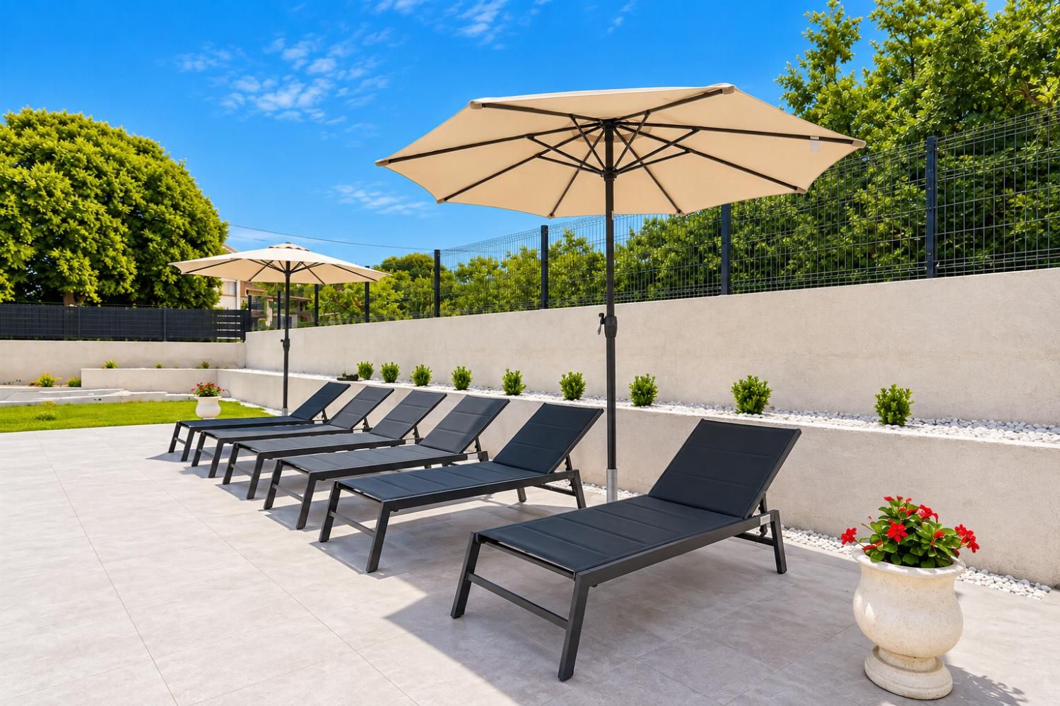 A series of sun loungers with attached umbrellas, arranged in rows on a tiled patio area.