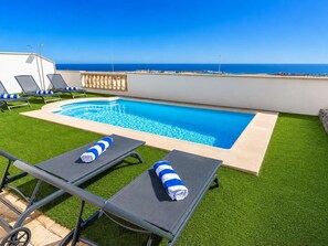 A rooftop pool with a clear view of the ocean, surrounded by lounge chairs and artificial grass. - Villa Anaiaks - Five Bedroom Villa, Sleeps 9 (Caleta de Fustes)