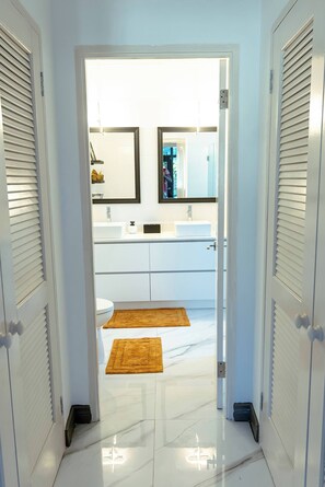 A bathroom with a white sink, mirror, and toilet. - Summer Escape-2br Apt-pool-7 Min Airport-pool (Montego Bay)