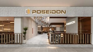A modern interior with a reception desk, seating area, and a visible brand name 'POSEIDON'. - Vinhomes Skylake Apartment - Layia Homes (Hanoi)