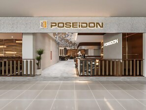 A modern interior with a reception desk, seating area, and a visible brand name 'POSEIDON'. - Vinhomes Skylake Apartment - Layia Homes (Hanoi)