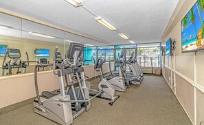 A gym with multiple treadmills, exercise bikes, and a mirrored wall. - Landmark 907 Ocean view studio (Myrtle Beach)