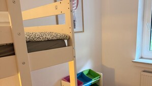A bunk bed with a pillow, a framed picture on the wall, and storage bins under the bed. - Holiday Apartment in Westfeld near Winterberg with Terrace and Nature Views (Schmallenberg)