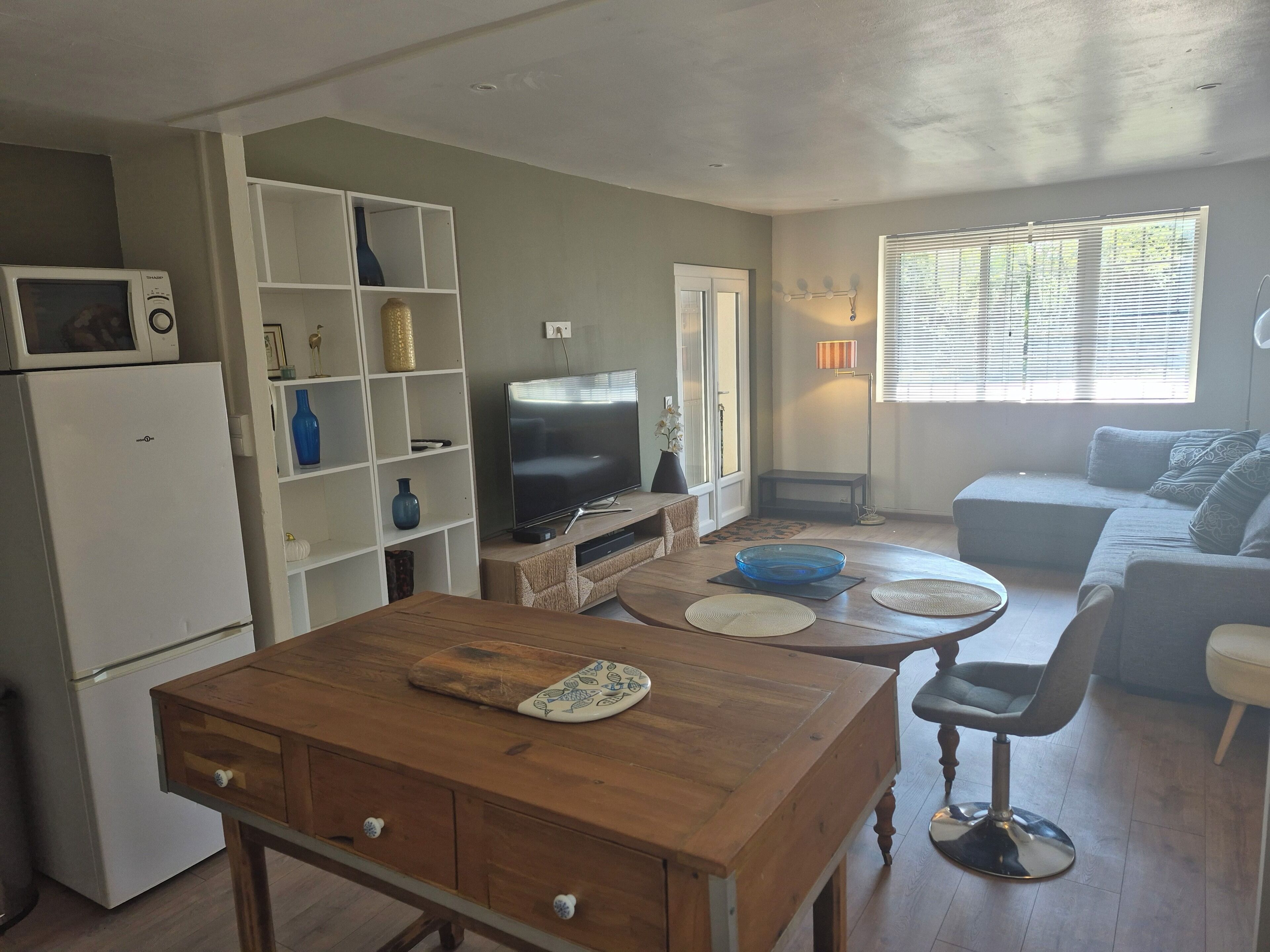 A compact living space with a kitchenette, a dining area, and a seating area.