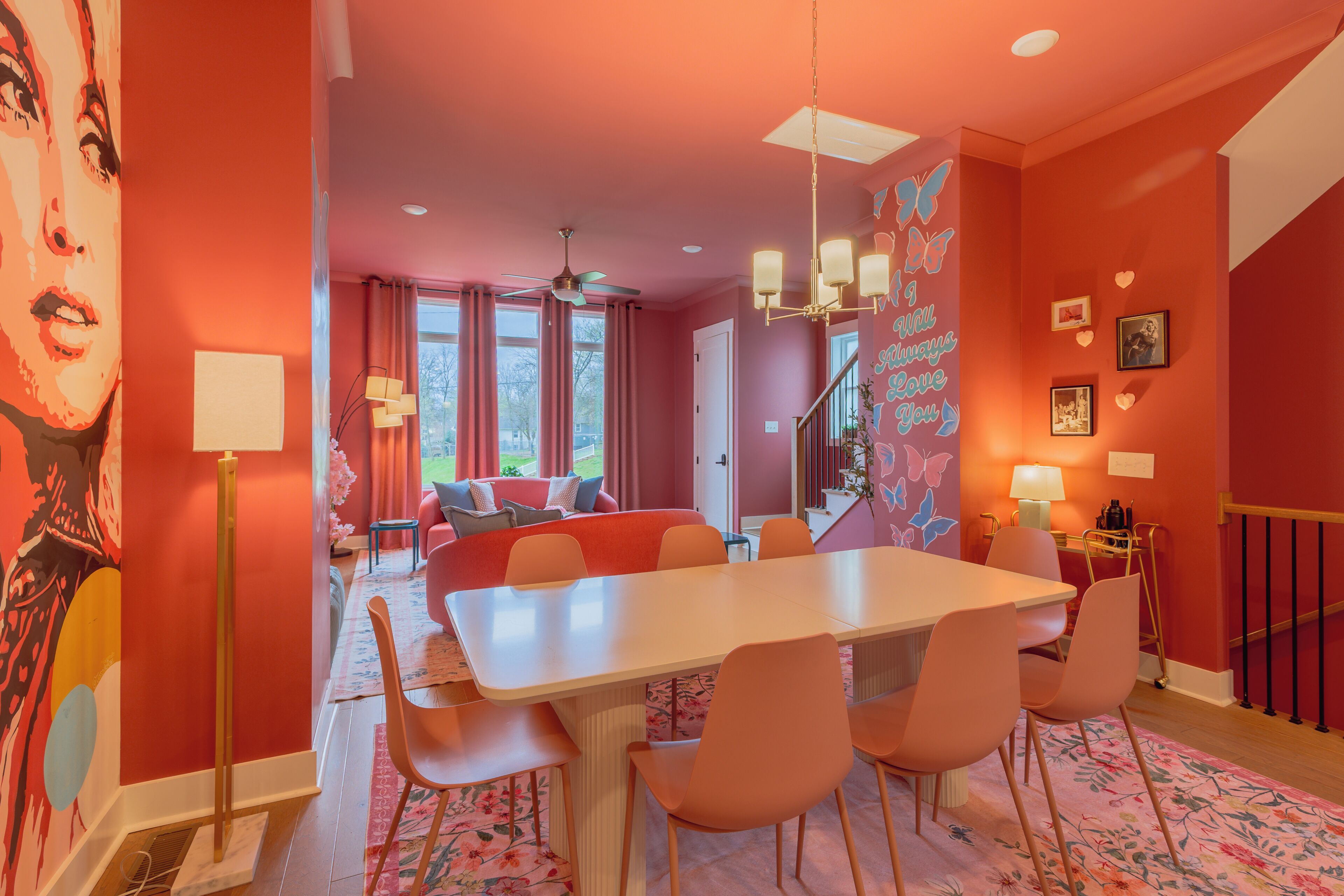 A modern interior with a dining area, a living room with a sofa, and a staircase.