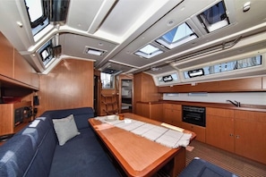 A compact galley with a wooden table, a built-in oven, and a sink.