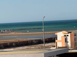 A beach with a pier, a building labeled 'Romance Beach,' and a streetlight. - Private Apartment in Hurghada (Égypte hurgada)