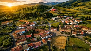 A rural village with traditional buildings, a central square, and surrounding green fields. - Casa Picos de Europa, Riaño: Rural House with Wi-Fi in a Natural Setting (Valle de las Casas)