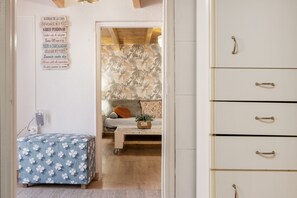 A bedroom with a bed, a nightstand, a dresser, and a wall with a list of phrases.