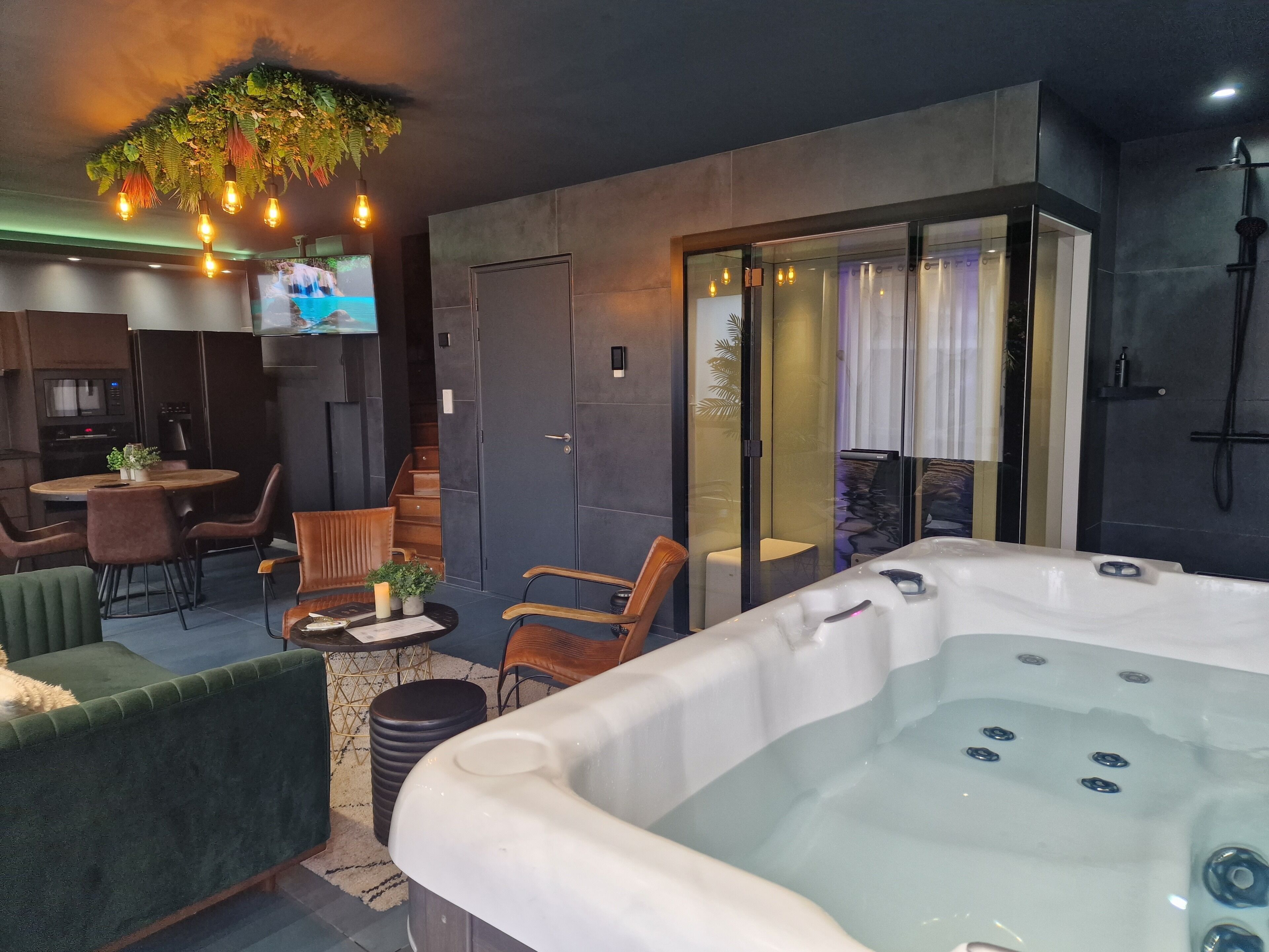 A modern interior with a hot tub, seating area, and a television.