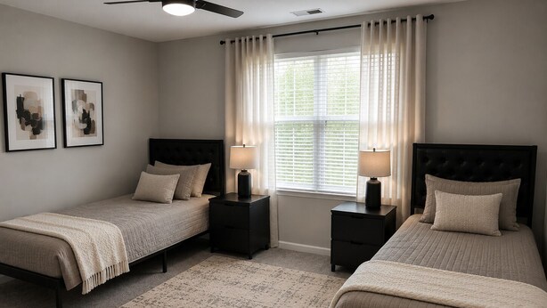 A bedroom with two beds, a ceiling fan, a window with curtains, and a rug.