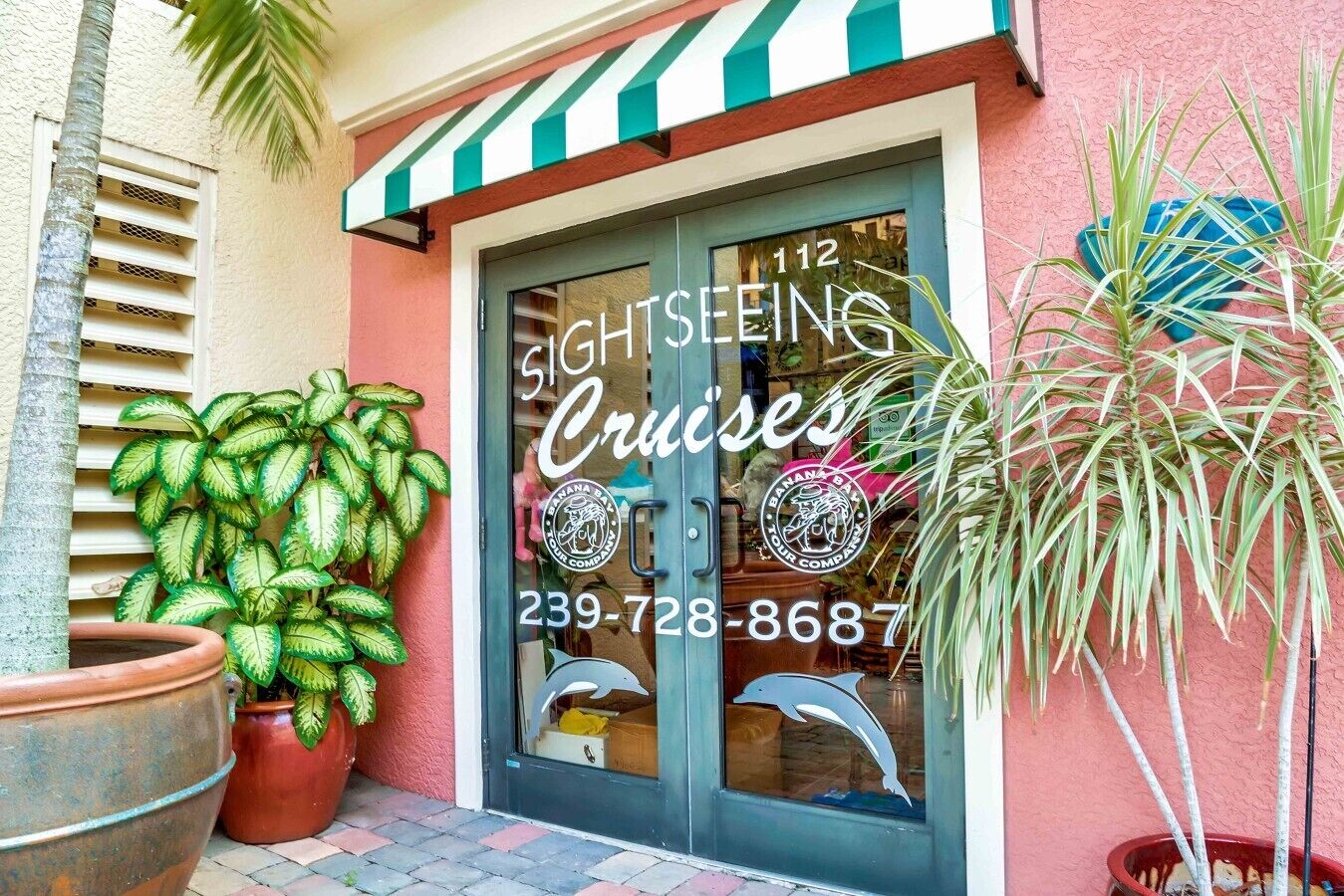 A building with a sign for 'Sightseeing Cruises' and a phone number.