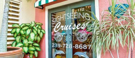 A building with a sign for 'Sightseeing Cruises' and a phone number.