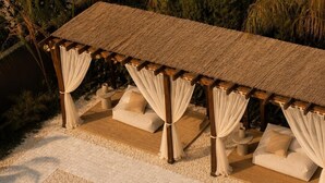 A poolside area with a covered seating area and a clear pool. - Leblanc Collection Mediterranean Villa 1 (Limmasol)