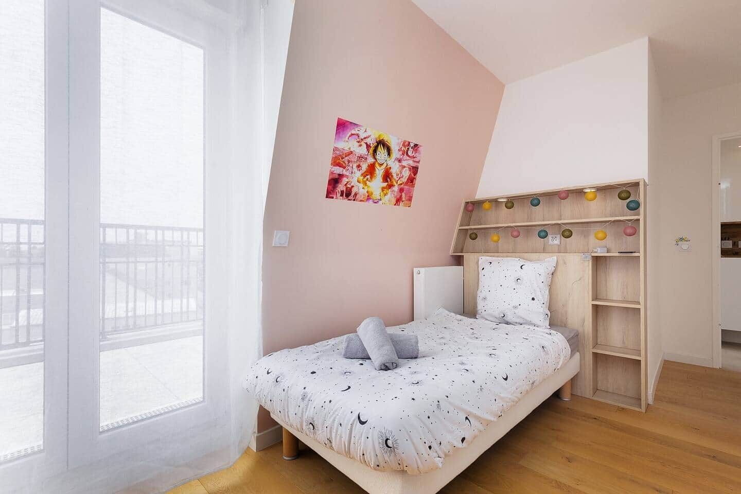 A bedroom with a bed, a headboard with shelves, a window, and a wall with a poster.
