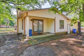 A single-story house with a covered porch, a sliding glass door, and a small front yard. - Spacious Family Escape Near Fort Bragg & Parks (Fayetteville)