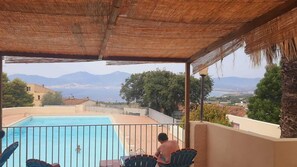 A pool with a view of mountains and a cityscape.