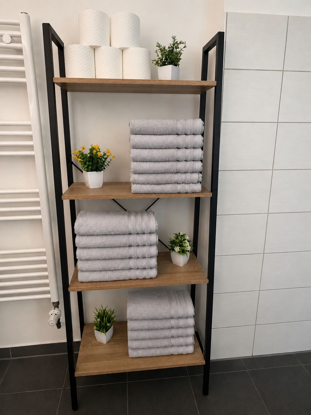 A shelf with towels and potted plants.