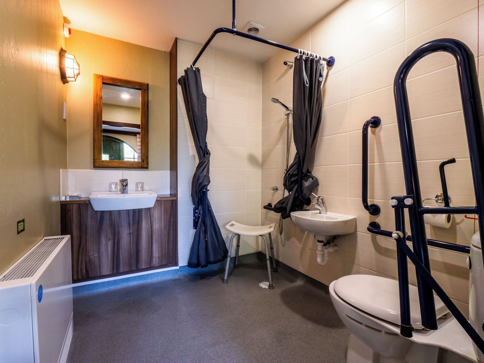 A bathroom with a shower, a sink, and a toilet.