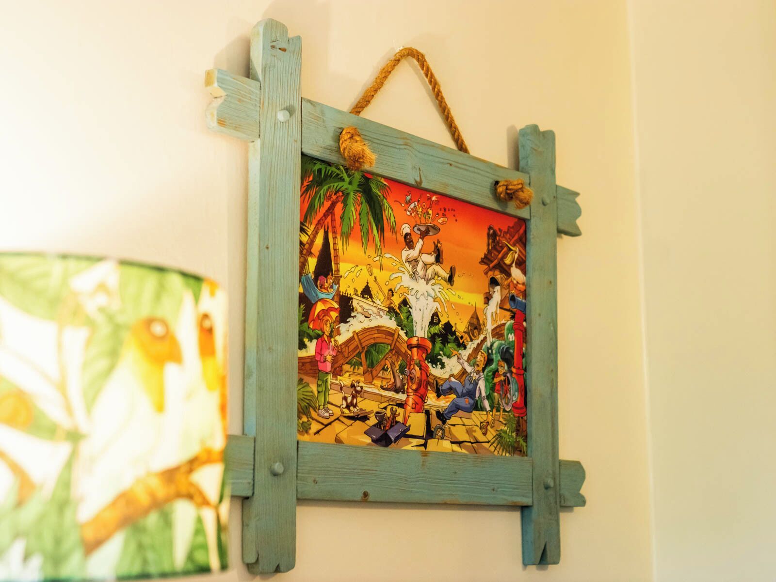 A wall-mounted wooden frame with a colorful illustration.