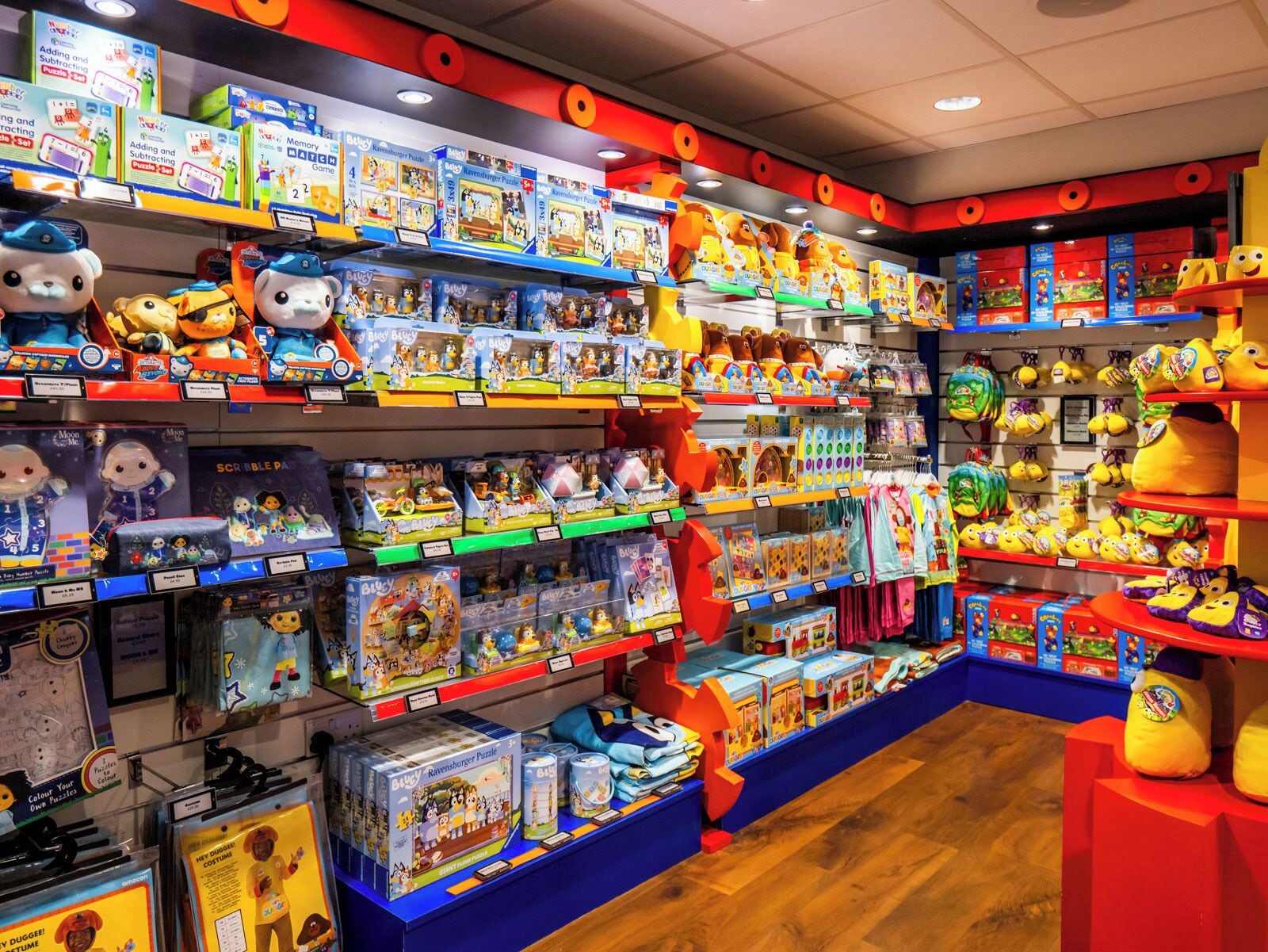 A brightly lit toy store with various puzzles and plush toys on shelves.
