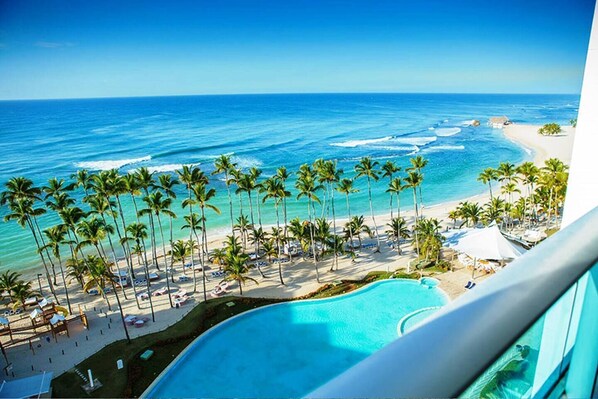 A resort with a pool, beach, and ocean view. - Beachfront Apartment in Juan Dolio, Getaway Offer! (Playa Juan Dolio)