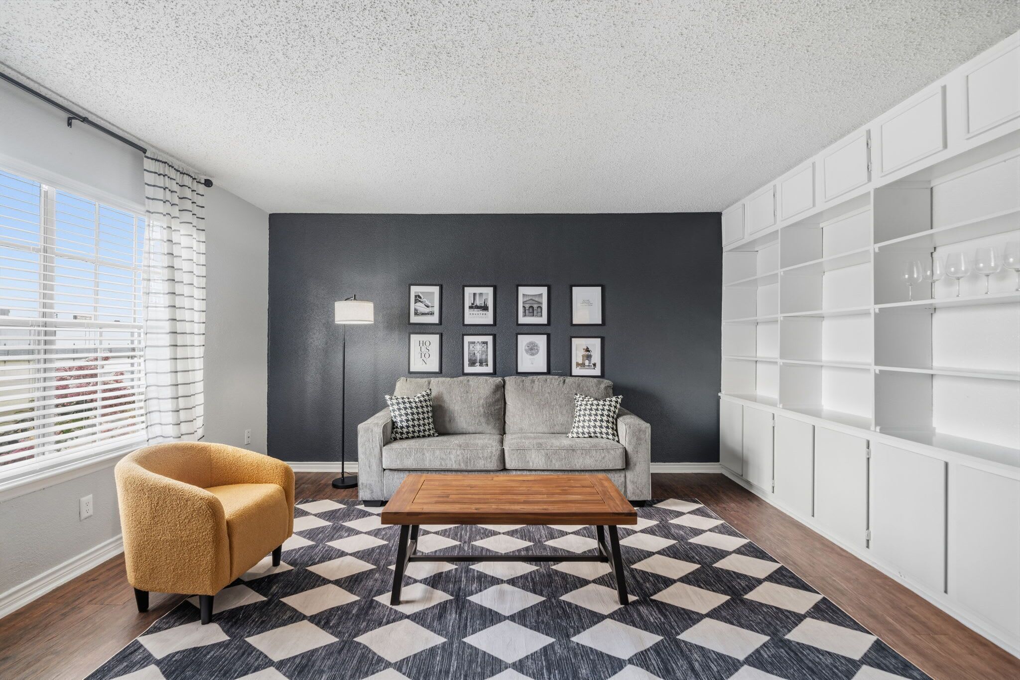 Chic living room with cozy seating and ample natural light, perfect for relaxation and gatherings.