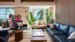 A modern living room with a leather sofa, a coffee table, and a gaming table. - The Happy Reef 4209 King & Queen (Tavernier)