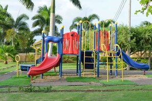 A playground with slides and climbing structures. - Sumfest ~ Draxhall ~ 24hr Gated ~ Pool (St Ann Jamaica)