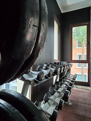 A row of dumbbells on a rack in a room with a window. - Espana Condo Resort Pattaya | 5 Mins To Jomtien Beach (ตำบล เมืองพัทยา)