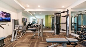 A gym with various exercise equipment, including weight machines and dumbbells. - Walk to the Brickyard 400! 2BR/2BA Apartment in Speedway, IN! (Speedway)