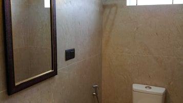 A bathroom with a sink, toilet, and shower.