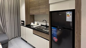 A modern kitchen with a built-in refrigerator, a microwave, and a sink. - 301 Al-najeh JRE Apartments For Rent ave (Amman)