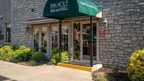A stone building with a green awning labeled '19th HOLE Bar and Grill.' - Welcome to Royale Retreat at Pointe Royal, in Branson, Missouri! (Branson)