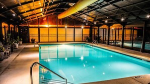 An indoor swimming pool with clear water, surrounded by a metal fence, and a covered roof structure. - Welcome to Royale Retreat at Pointe Royal, in Branson, Missouri! (Branson)