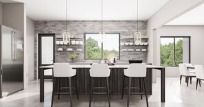 A modern kitchen with a central island, bar stools, and a large window offering a view of greenery.