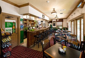 A restaurant with a bar area, multiple tables, and chairs. - Welcome to Relaxation Pointe at Pointe Royale in Branson, Missouri! (Branson)