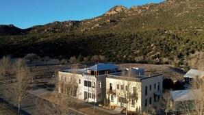 A two-story building with a flat roof, large windows, and a visible balcony. - Rooftop Views, Walk to Downtown, Sleeps 13 (Buena Vista)