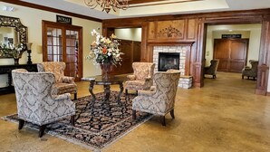 A lobby with a chandelier, a fireplace, and two armchairs. - Welcome to Royale Relaxation at Pointe Royale in Branson, Missouri! (Branson)