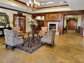 A lobby with a chandelier, a fireplace, and two armchairs. - Welcome to Royale Relaxation at Pointe Royale in Branson, Missouri! (Branson)