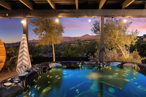 An outdoor hot tub area with a view of mountains and trees at dusk. - Desert Dreams: private pool, sauna, cold plunge, star dome, gym and theatre (Yucca Valley)