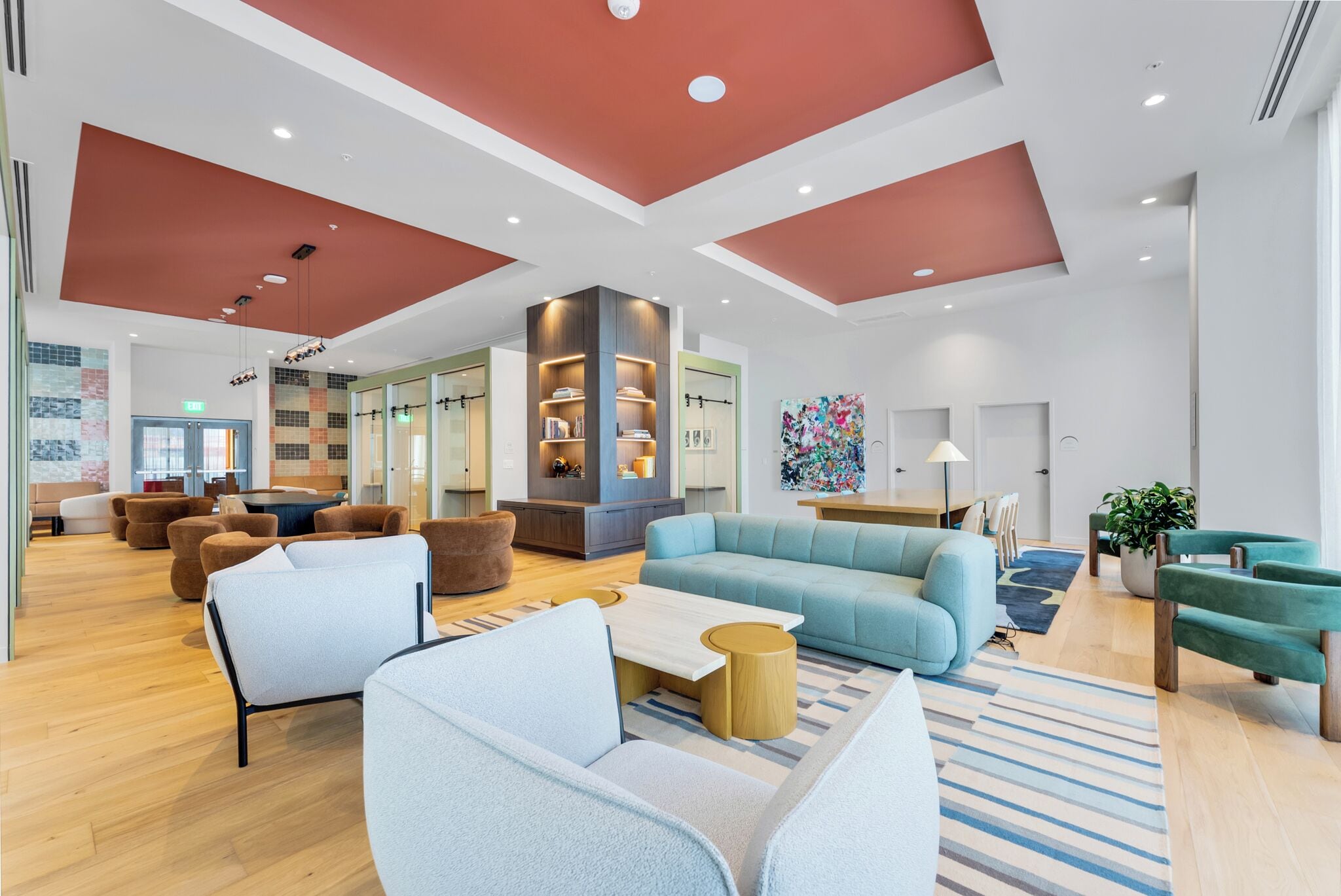 A spacious lobby with a high ceiling, modern furniture, and a central seating area.