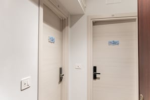 Two doors with a light wood finish, each with a small sign above the door handle. - [Luxury Suite] Levante Apartment (Giovinazzo(BA))