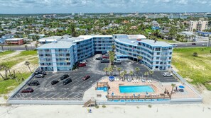 A multi-story hotel with a pool and beach area, surrounded by a parking lot. - Oceanview Studio, 2 Pools, Beach, Game Room, Patio (Daytona Beach)