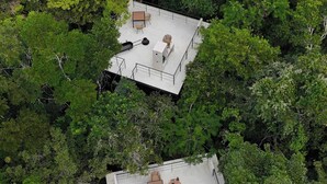 Two elevated outdoor areas with seating and a barbecue grill, surrounded by dense forest. - Tree60:· Jungle Villa Private Rooftop&Wood-Hot Tub (Chemuyil)