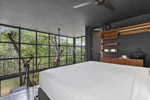 A bedroom with a large window, a bed, a ceiling fan, and built-in wooden shelves. - Tree60:· Jungle Villa Private Rooftop&Wood-Hot Tub (Chemuyil)