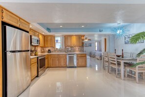 A modern kitchen with wooden cabinets, stainless steel appliances, and a central island. - Pet-Friendly Daytona Beach Home Near the Beach (Daytona Beach)
