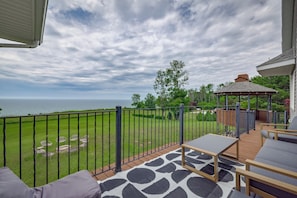 A balcony with a view of the sea, a gazebo, and outdoor seating. - Lake Michigan Retreat! Beautiful Views & Amazing Amenities (Ludington)